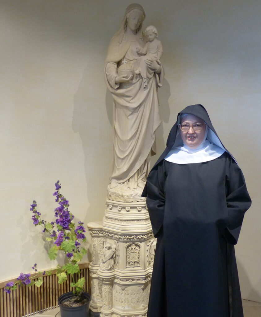 Sr Therese stood by the statue of Our Lady of Consolation
